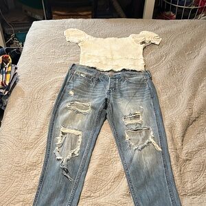 HOLLSTER Women’s Light Blue Distressed Jeans with white ruffle stretch top